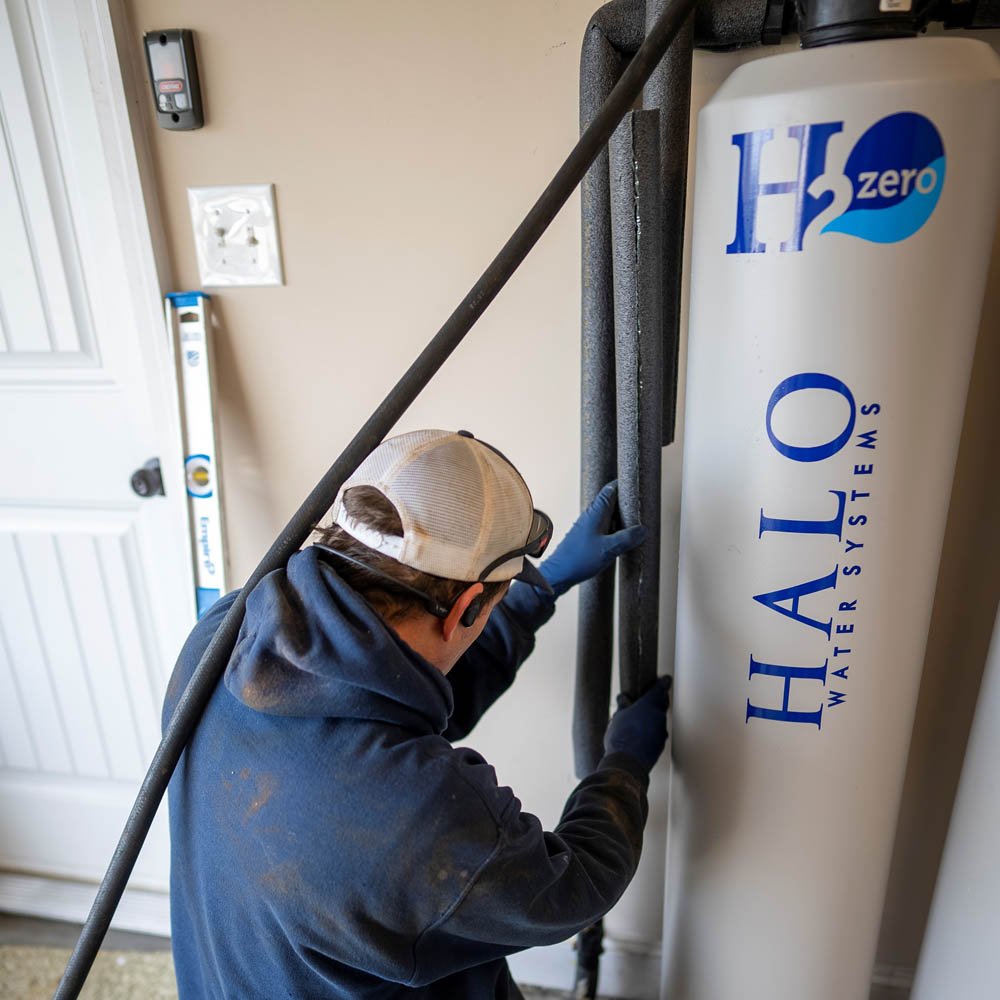 plumber installing a halo water system